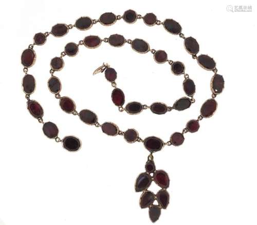 Antique unmarked gold and garnet necklace, (tests at 9ct gold), 34cm in length, 17.0g : For