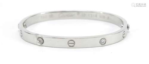 18ct white gold bangle set with clear stones, housed in a Cartier tooled leather box, the bangle