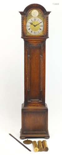 Tempus Fugit oak longcase clock, striking on eight rods, the ornate dial with silvered chapter ring,