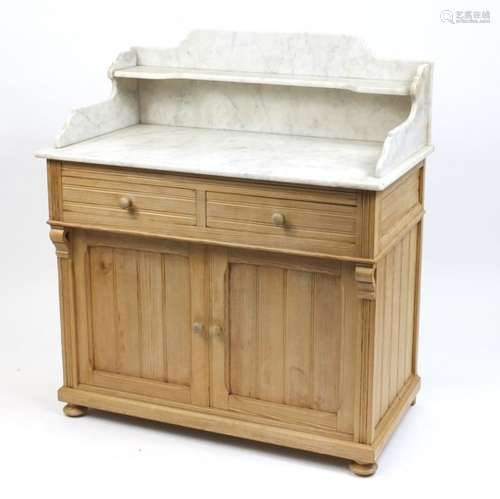 Pine wash stand with marble top above two drawers and a pair of cupboard doors, 112cm H x 100cm W