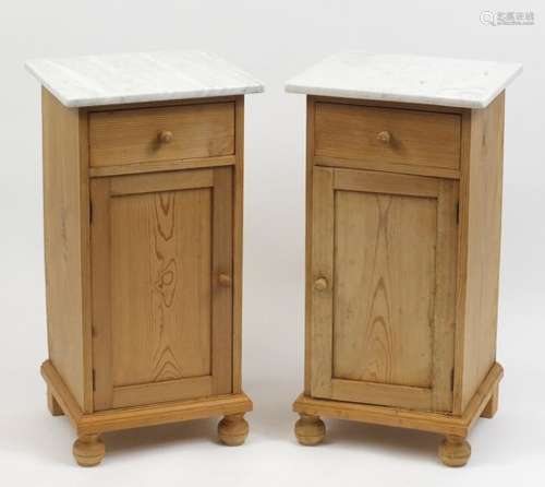 Pair of pine night stands each with marble top above a drawer and cupboard door, 81cm H x 42cm W x