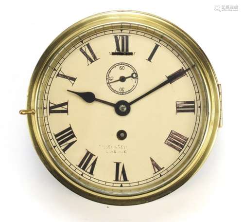 Brass ships bulk head design clock, with Roman numerals, the dial inscribed Lilley and Reynolds of