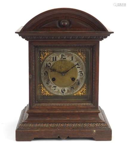 Oak cased mantle clock by Junghans striking on two gongs, the ornate dial having a silvered