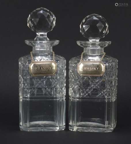 Near pair of cut glass decanters with silver decanters labels, Whisky and Brandy, the larger 23cm