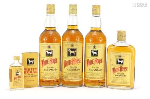 Five bottles of vintage White Horse Whisky, one with box, comprising sizes 75.7cl, 75cl, 37.5cl