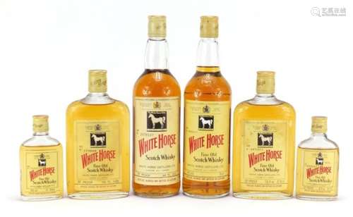 Six bottles of vintage White Horse Whisky, one with box, comprising sizes 75cl, 37.8cl and 9.4cl :