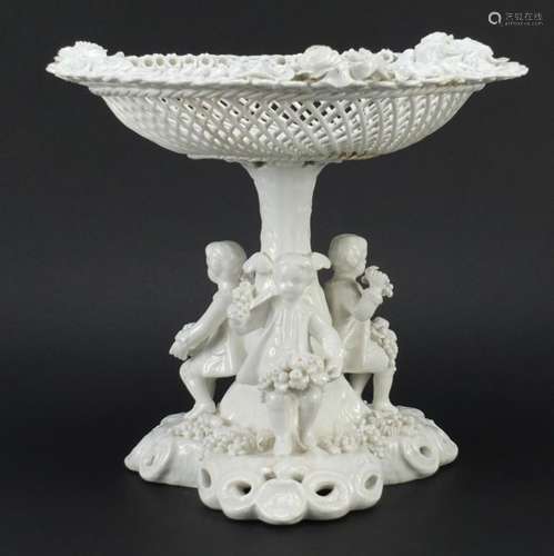 Continental porcelain centre piece modelled with three children holding fruit, 25.5cm high by 28cm