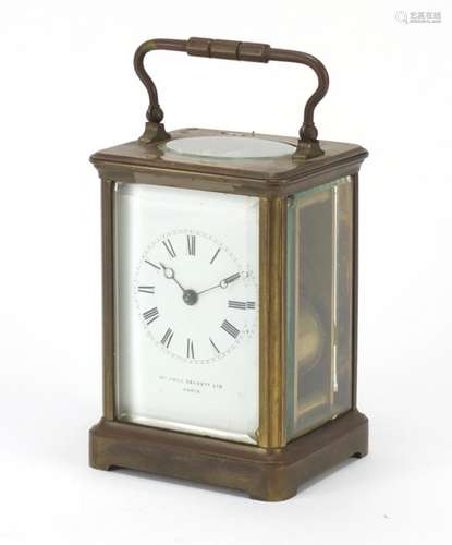 Large brass cased carriage clock striking on a gong, enamelled dial with Roman numerals inscribed