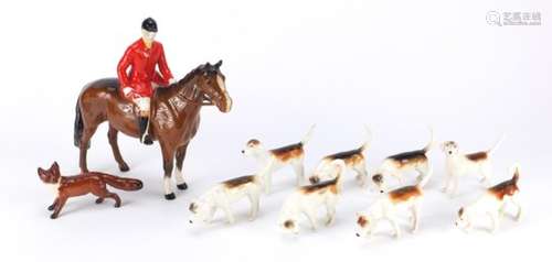 Beswick huntsman on horseback with eight hounds and a fox, the largest 21cm high : For Further