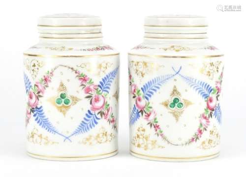 Pair of continental porcelain canisters with covers, hand painted and gilded with flowers, 17cm high