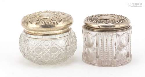 Two Victorian cut glass jars with silver lids, embossed with flowers, both Birmingham 1904, the