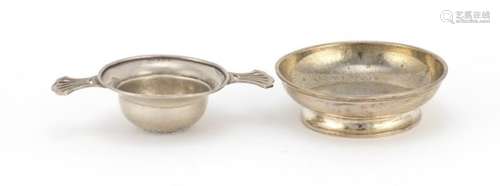 Circular silver pedestal bowl and a twin handled sifter, London and Birmingham hallmarks, the