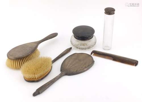 Silver mounted vanity items including a pair of brushes, hand mirror and cut glass powder pot,