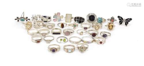 Thirty-three silver rings some set with semi-precious stones, various sizes, 125.8g : For Further