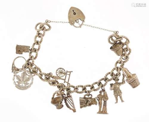 Silver charm bracelet with collection of mostly silver charms including Toby Jug, champagne