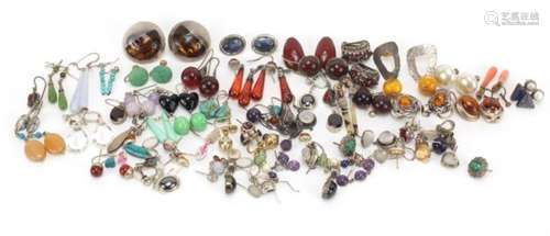 Large selection of mostly silver earrings some set with semi-precious stones including amber,