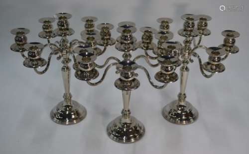 A set of three seven-sconce candelabra