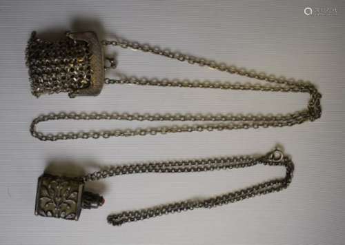 A white metal mesh pendant in the form of a purse