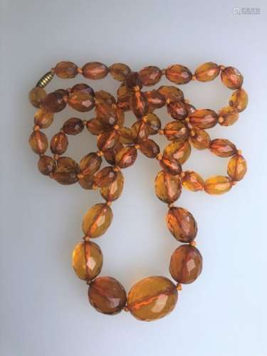 A row of graduated facetted amber beads