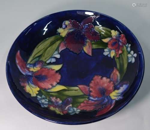 A large Moorcroft shallow bowl decorated in the 'Slipper Orchid' pattern