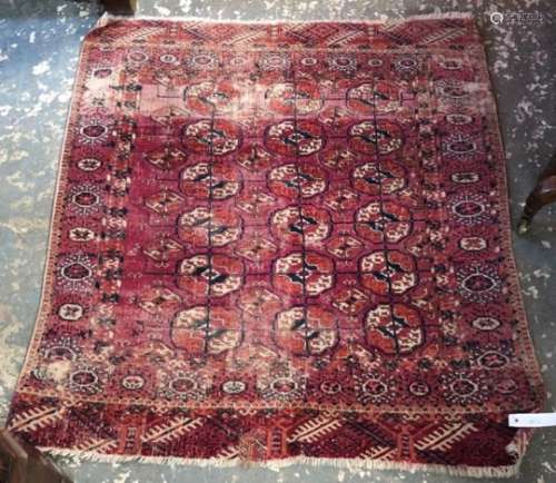 An antique Turkman rug, the field of geometric guls on red ground