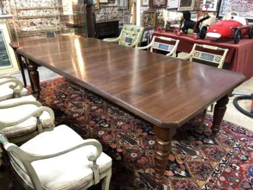 A Victorian walnut wind-out extending dining table, with two insert leaves