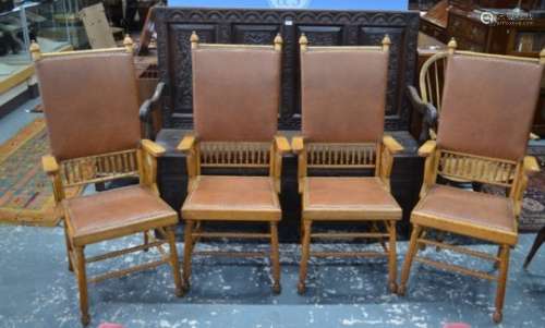 An unusual set of four Arts & Crafts period oak framed high back elbow chairs (4)