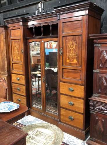 A late Victorian inlaid mahogany inverted breakfront wardrobe