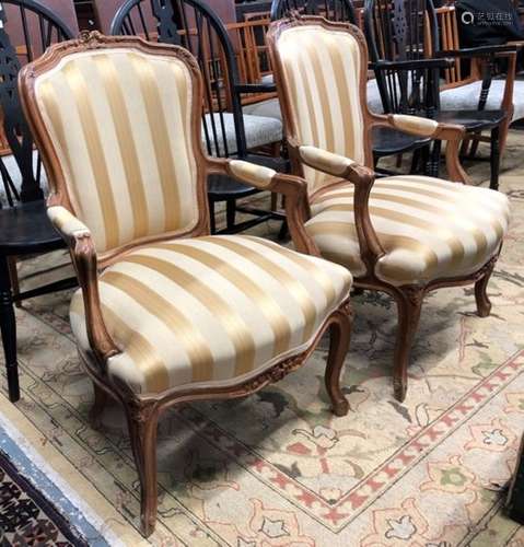 A pair of Louis XV style salon armchairs, with yellow/gold fabric overstuffed seat and back panel