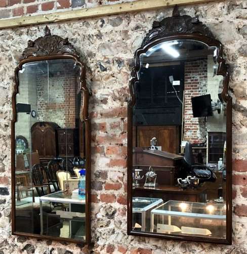 A matched / companion pair of similar moulded walnut framed bevel edged plate mirrors