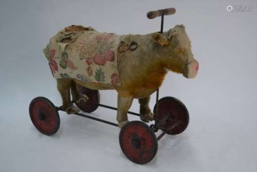 A child's antique straw-stuffed ride-on cow