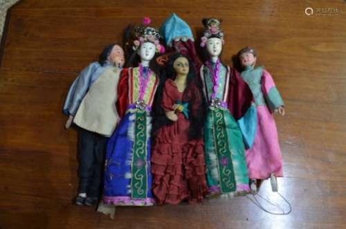 Four Chinese costume dolls and a Spanish costume doll