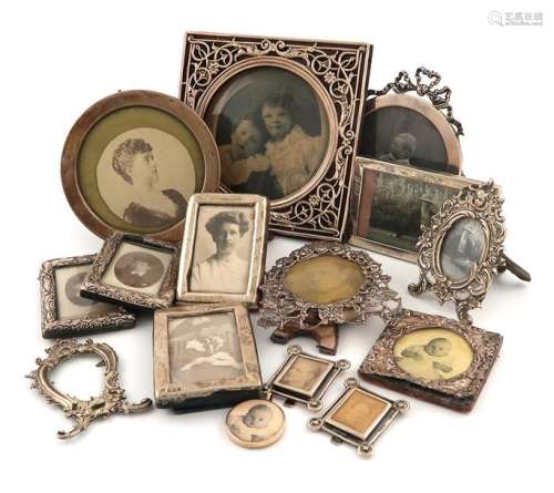 A collection of fourteen silver photograph frames,…