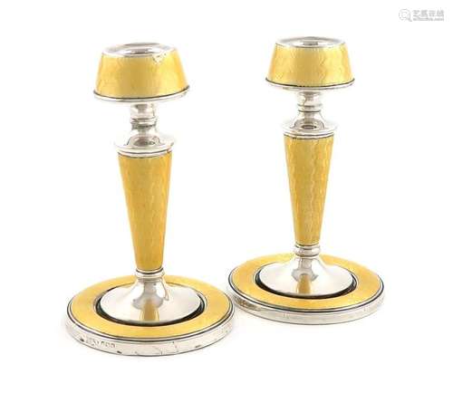 A pair of silver and yellow enamel candlesticks, b…