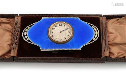 A silver gilt and blue enamel travelling clock, by…