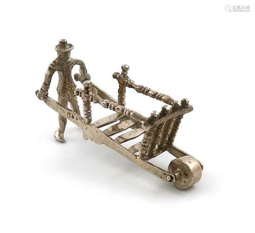 A Dutch miniature silver man and wheelbarrow, mark…