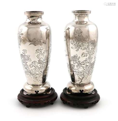 A pair of Japanese silver vases, marked to the und…