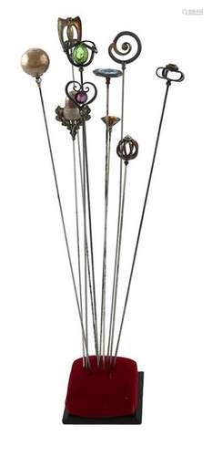 A collection of silver hatpins, comprising: four b…