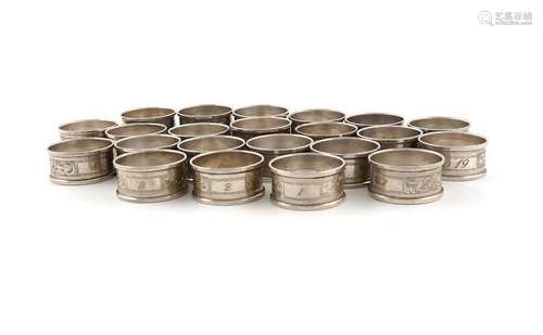 A matched set of twenty two silver napkin rings, b…