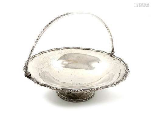 An Edwardian silver swing handled cake basket, by …