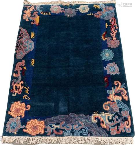 China rug. The plain blue background is surrounded…