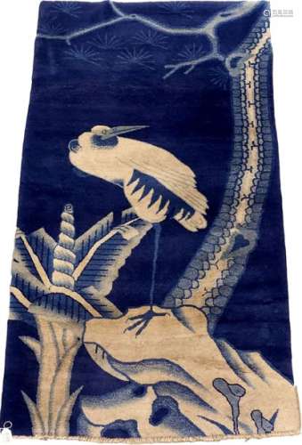 China rug. It features a large stork perched on a …