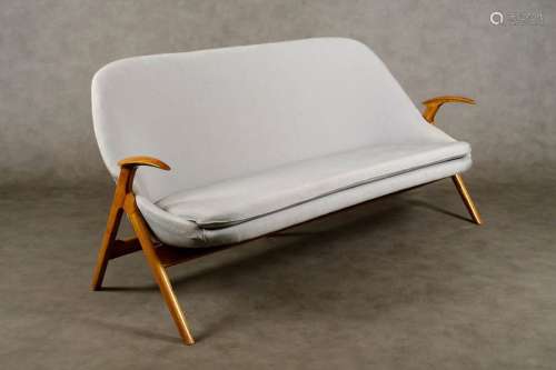 Design sofa. Monocoque seat resting on a crossed b…