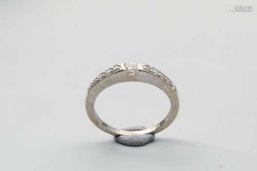 White gold ring with a diamond studded ring and a …