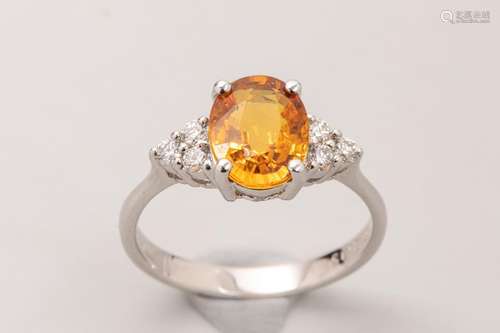 18k white gold ring set with an oval cut yellow sa…