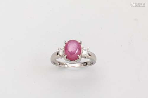 Platinum ring set with a star ruby cabochon of abo…