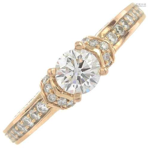An 18ct gold diamond single-stone ring, with pave-set