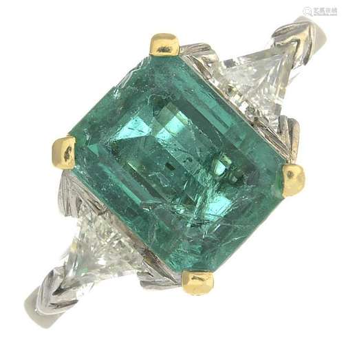 A platinum emerald and diamond ring.Emerald calculated