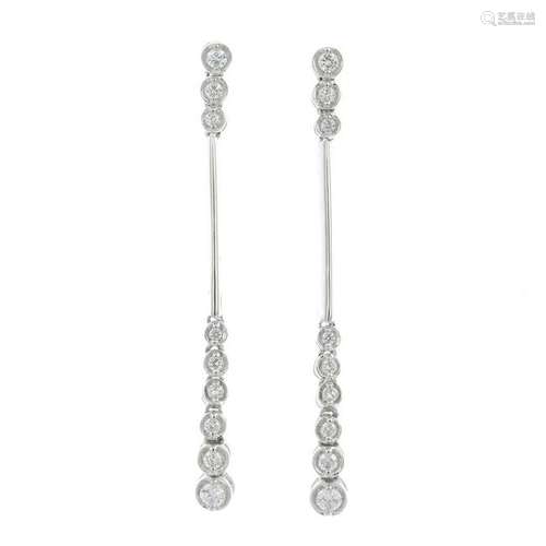 A pair of diamond earrings.Total diamond weight 0.25ct,