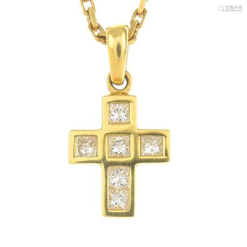 An 18ct gold diamond cross pendant, suspended from a